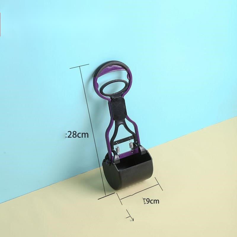 Dog cleaning feces shovel with an ergonomic handle, shown in use outdoors for hygienic and mess-free waste removal.