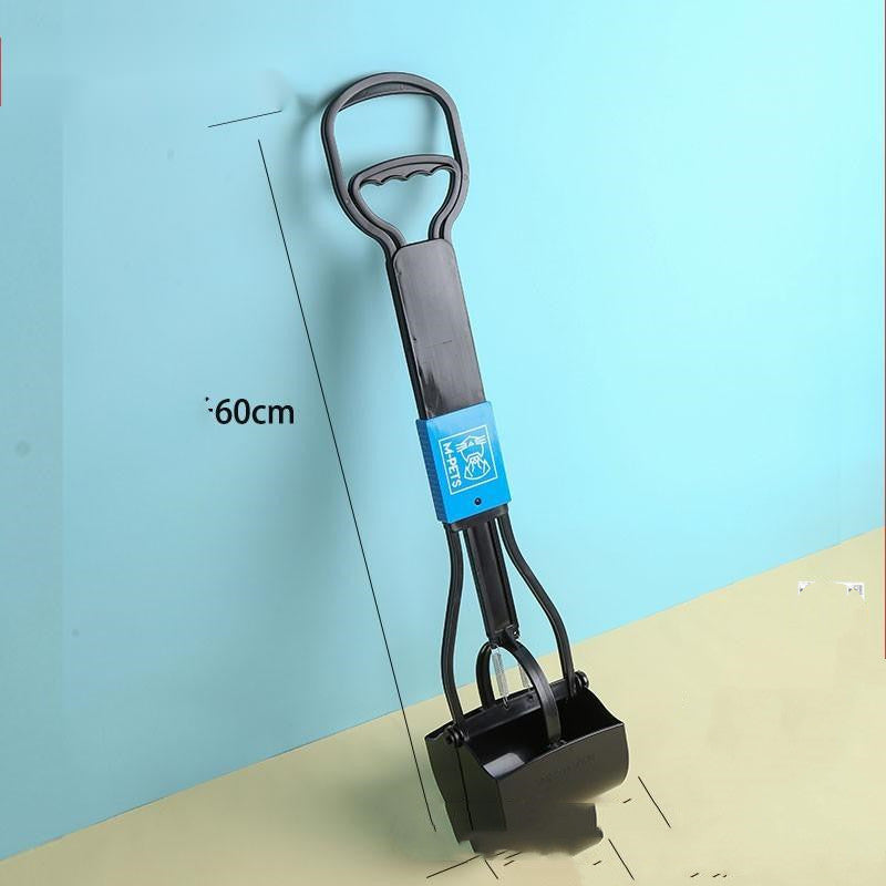 Dog cleaning feces shovel with an ergonomic handle, shown in use outdoors for hygienic and mess-free waste removal.